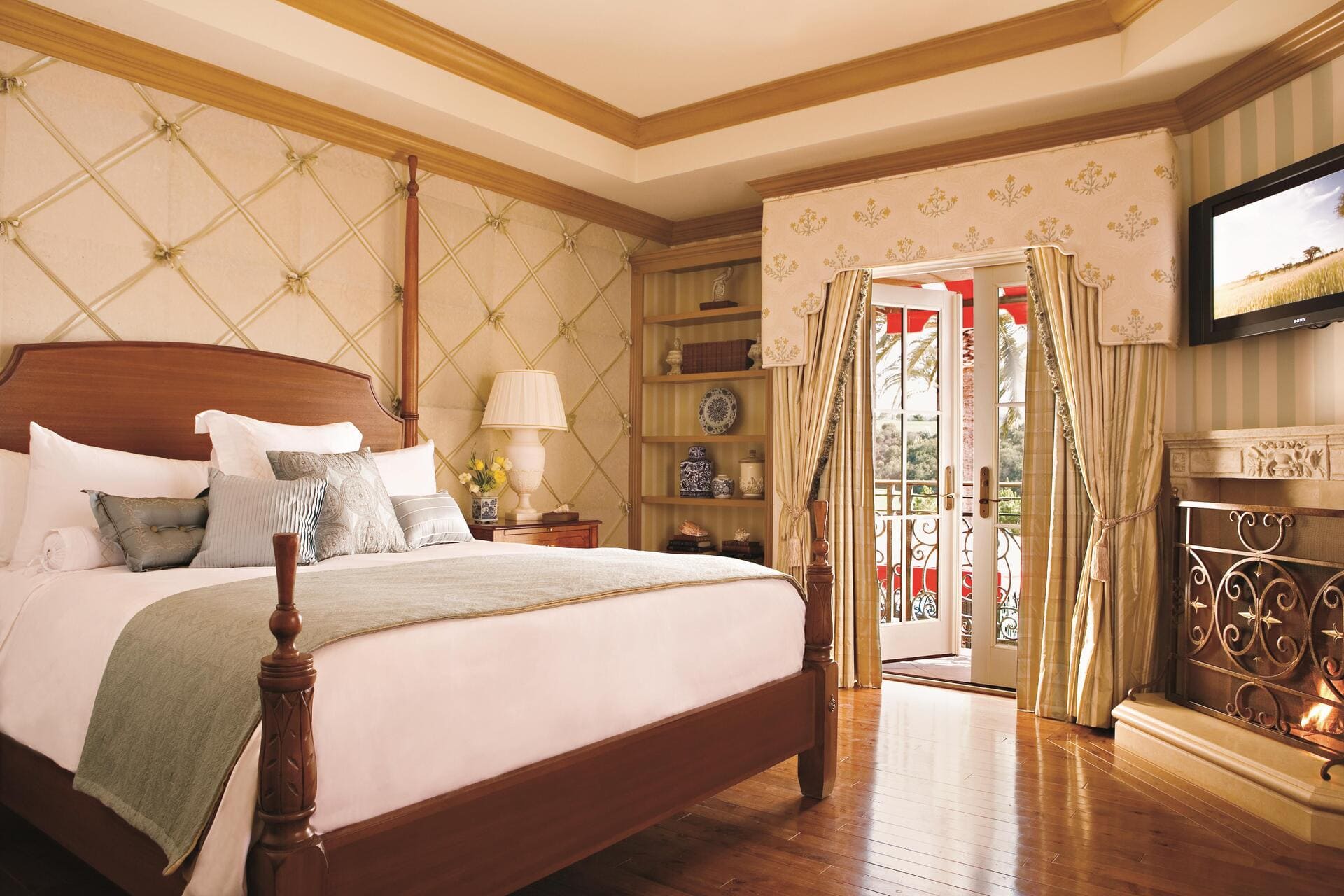 Villa bedroom with fireplace and balcony