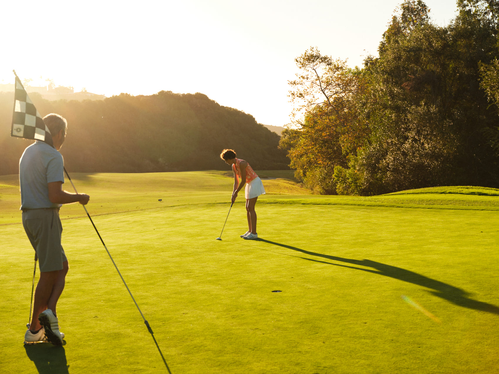 Man and woman playing golf
