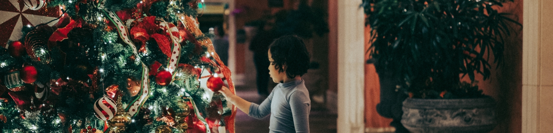 girl at Christmas tree at Fairmont Grand Del Mar