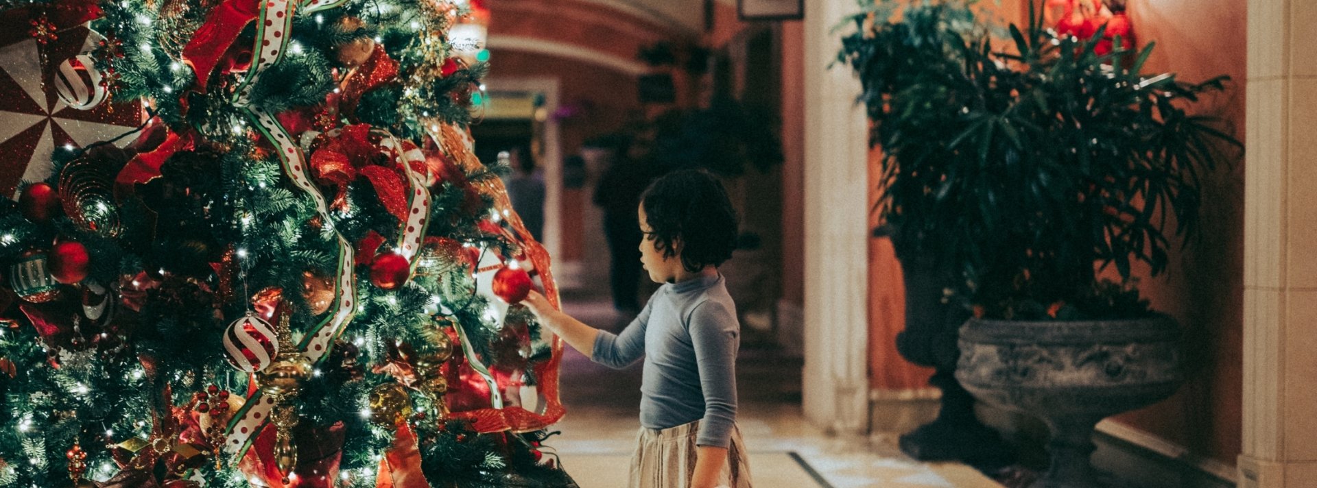 girl at Christmas tree at Fairmont Grand Del Mar