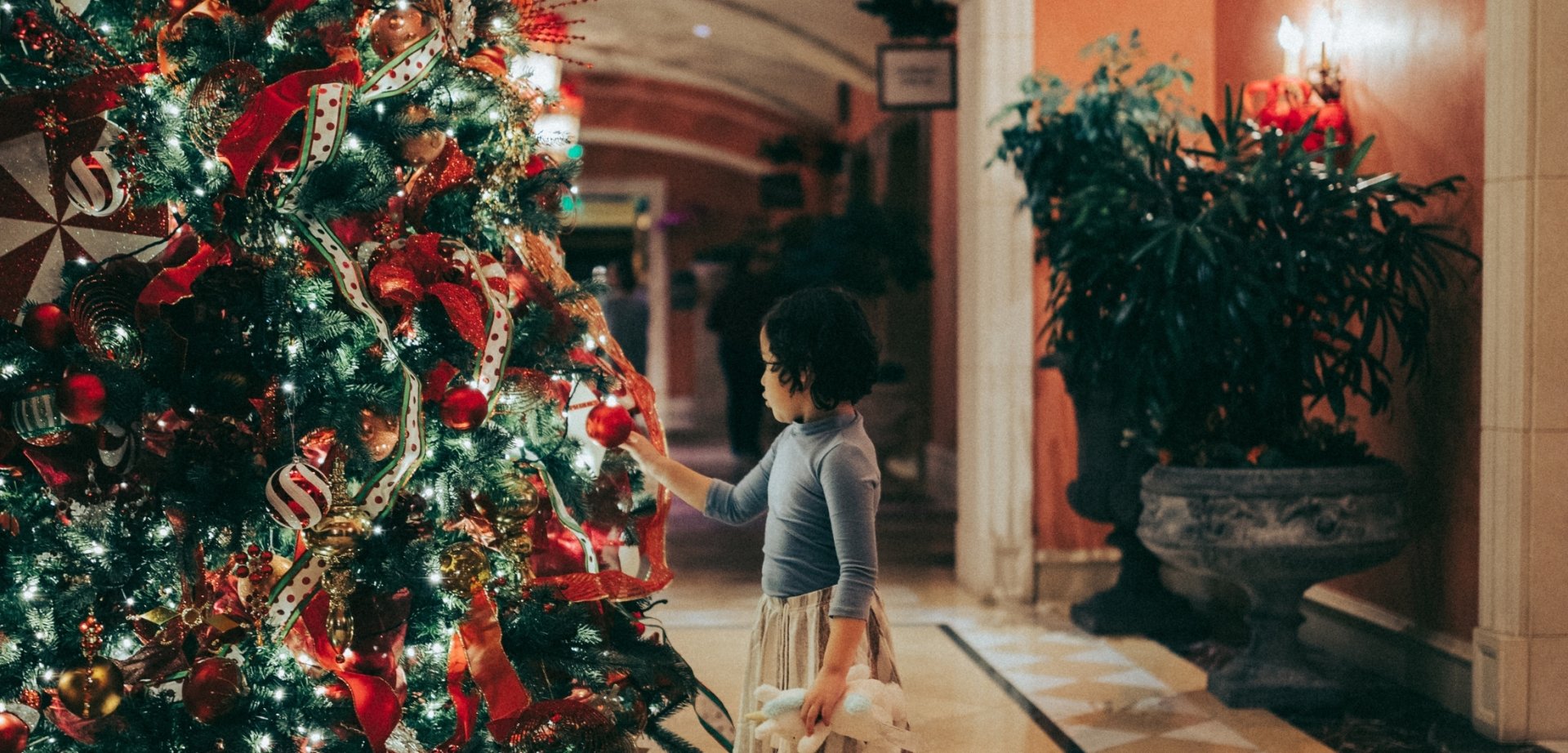 girl at Christmas tree at Fairmont Grand Del Mar