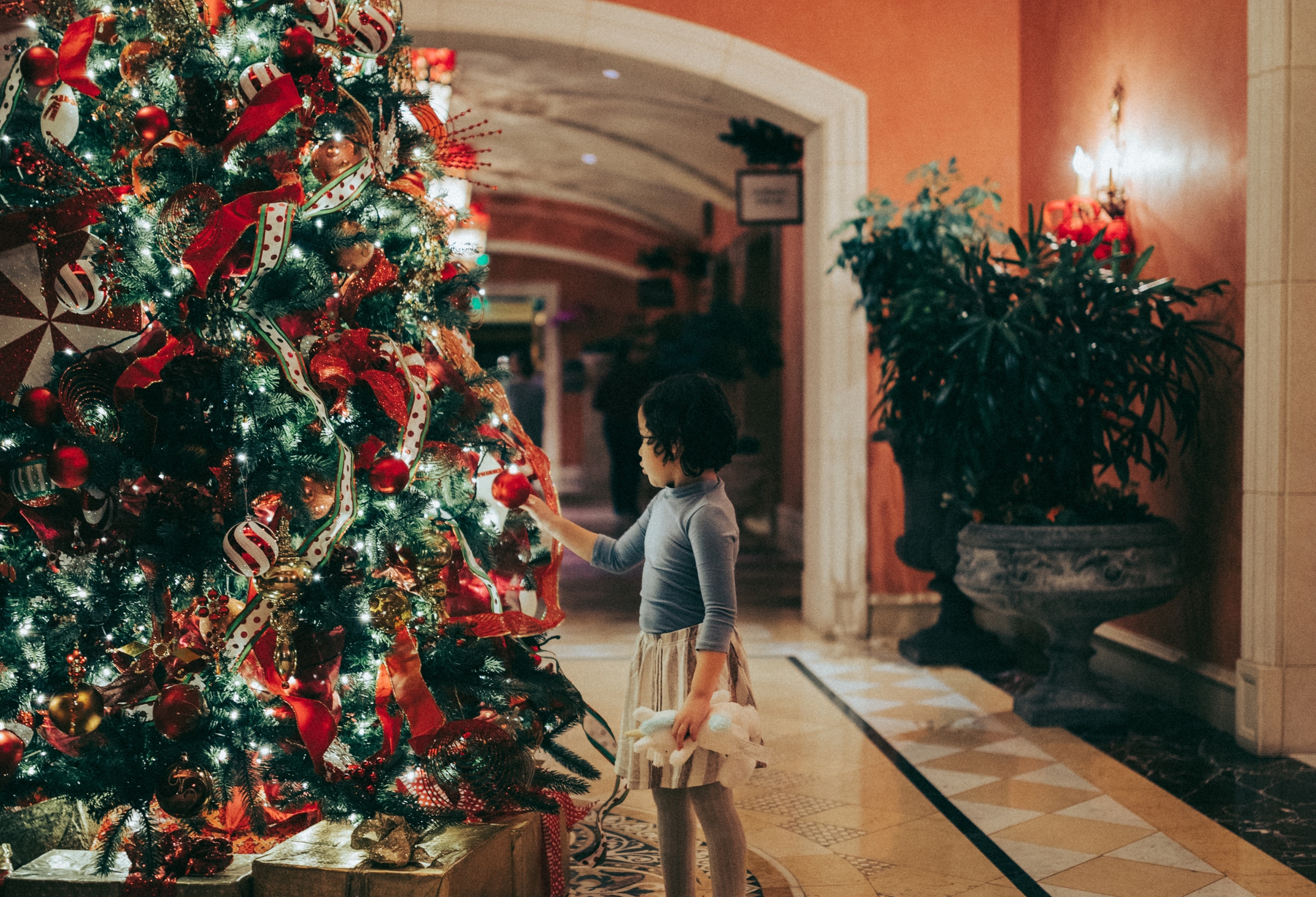 girl at Christmas tree at Fairmont Grand Del Mar