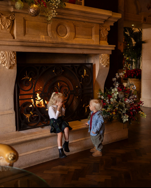 kids at Fireplace during the holidays in the Lobby Lounge at Fairmont Grand Del Mar.